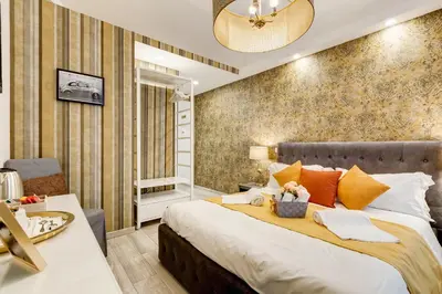a bedroom with a large bed with orange pillows at Maison Risorgimento in Rome
