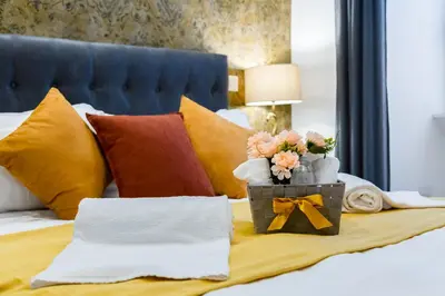 a bed with a box of flowers on it at Maison Risorgimento in Rome