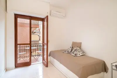 a bedroom with a bed and a balcony at Magenta Collection Terrione 17 in Rome