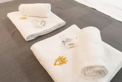 two white towels on a table with a napkin at Magenta Collection Terrione 17 in Rome
