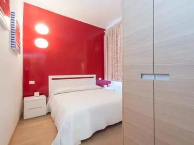 a red bedroom with a white bed and a red wall at Spagna Sistina 143 in Rome