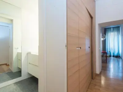a hallway with a large wooden door in a house at Spagna Sistina 143 in Rome