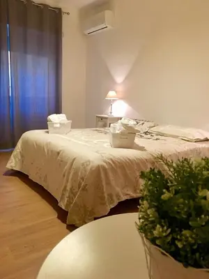 a room with a bed with a table and a plant at Casa Milù in Rome
