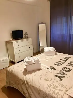 a bedroom with a bed with a dresser and a mirror at Casa Milù in Rome