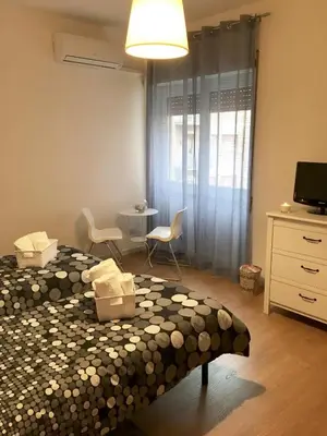 a bedroom with a bed and a table and chairs at Casa Milù in Rome