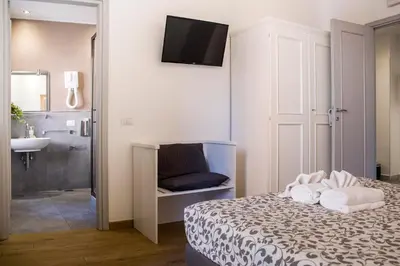 a bedroom with a bed and a bathroom with a sink at Dulcis In Vatican b&b in Rome
