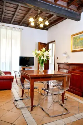 a living room with a couch and a chair at Confortevole Appartamento nel Centro Storico con 2 camere AC WiFi in Rome