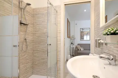 a bathroom with a sink and a glass shower at Cave98 Apartment in Rome
