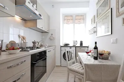 a kitchen with a table with wine glasses on it at Cave98 Apartment in Rome