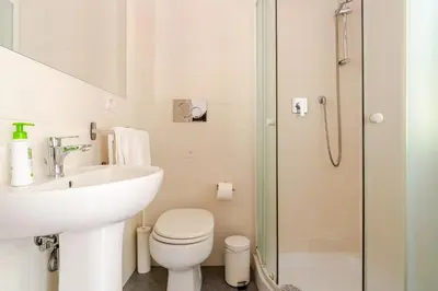 a bathroom with a sink and a toilet and a shower at St. Peter Garden House in Rome