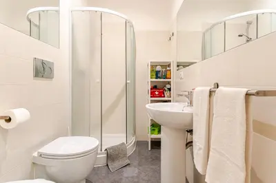a white bathroom with a toilet and a sink at St. Peter Garden House in Rome