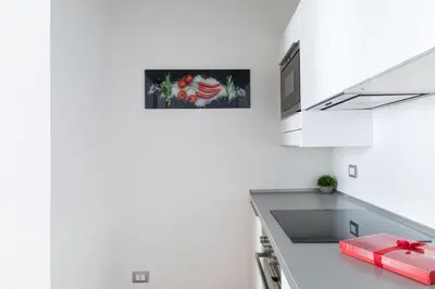a kitchen with white walls and a white counter top at A World Aparts - 87 Boschetto in Rome