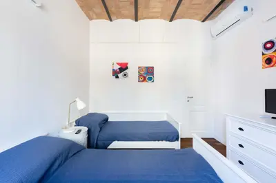 a bedroom with a blue bed and a tv at Saint Peters Luxury 3 Bedrooms Apartment in Rome