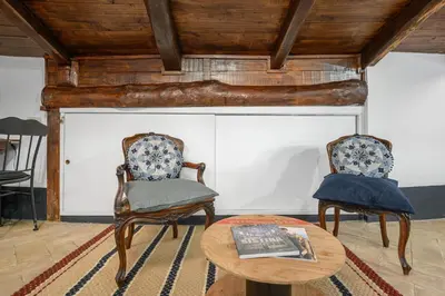 a living room with two chairs and a table at Casa Nora in Rome