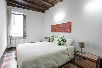 a bedroom with a bed and a sign on the wall at Casa Nora in Rome