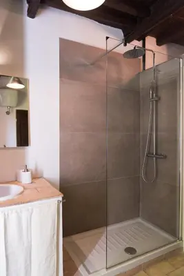 a shower with a glass door in a bathroom at Casa Nora in Rome