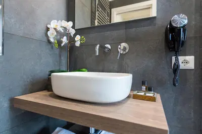 a bathroom with a large white bowl sink on a counter at Rent Rooms Trastevere in Rome