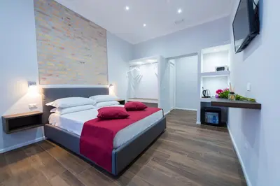 a bedroom with a large bed with a red blanket at Rent Rooms Trastevere in Rome