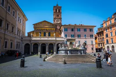 a building with a fountain and a clock tower at Rent Rooms Trastevere in Rome