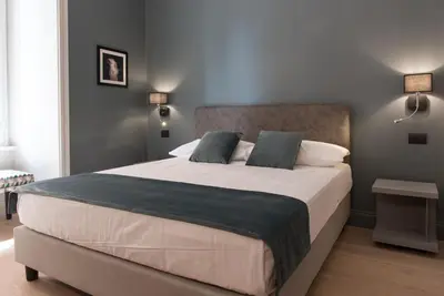 a bedroom with a large bed with two pillows at Domus Alberico in Rome