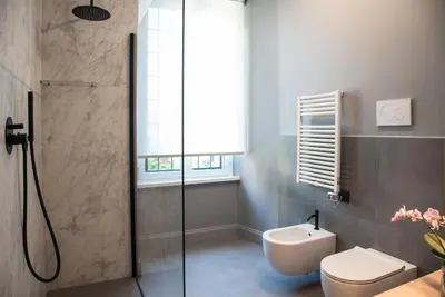 a bathroom with a shower and a toilet and a sink at Domus Alberico in Rome