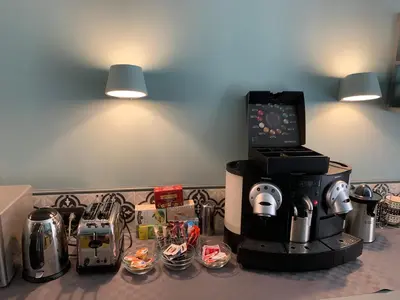 a kitchen counter with a coffee maker and other appliances at Domus Alberico in Rome