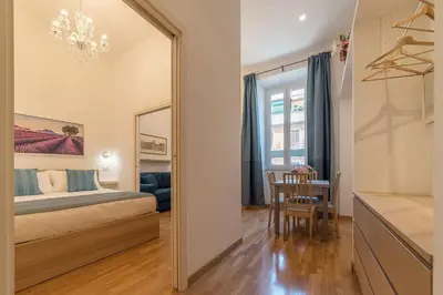 a bedroom with a bed and a table and a mirror at CS Termini Nazionale Apartments in Rome