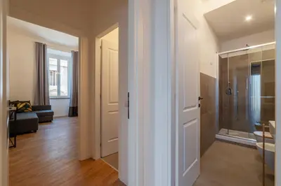a hallway with a door leading to a living room at CS Termini Nazionale Apartments in Rome
