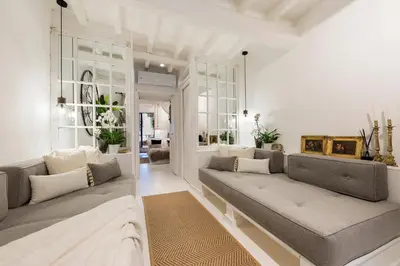 a living room with two couches and a table at Trastevere Gem Cozy Light-filled Retreat in Rome