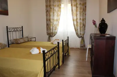 two twin beds in a bedroom with a window at ART APARTMENT VILLA FIORELLI in Rome