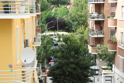 a view of a city street from between buildings at ART APARTMENT VILLA FIORELLI in Rome