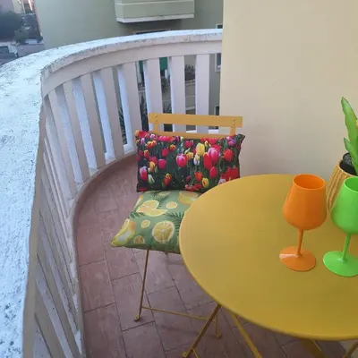 a table and a chair next to a yellow table and a table and chair at ART APARTMENT VILLA FIORELLI in Rome