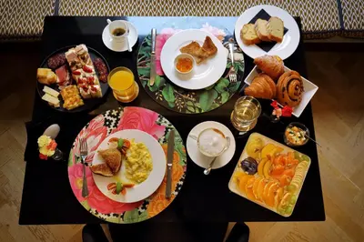 a black table topped with plates of breakfast food at Roma Five Suites in Rome