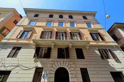 a tall building with a balcony on top of it at Roma Five Suites in Rome