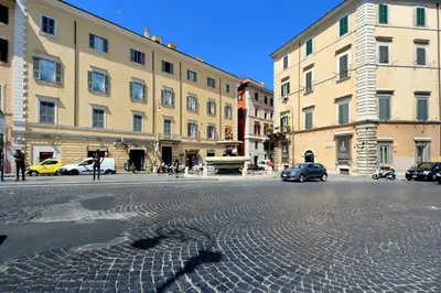 a cobblestone street in a city with buildings at Roma Five Suites in Rome