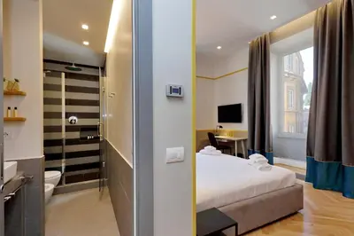 a hotel room with a bed and a bathroom at Roma Five Suites in Rome