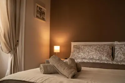 a bedroom with a bed with two pillows on it at Sogno di un'epoca in Rome