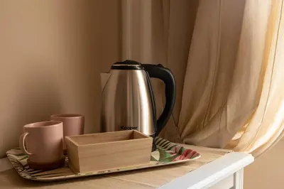 a coffee pot on a tray next to cups on a table at Sogno di un'epoca in Rome