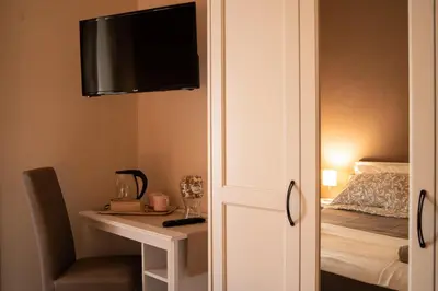 a room with a desk and a television on a wall at Sogno di un'epoca in Rome
