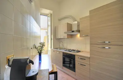 a kitchen with a table and a stove top oven at Rome Luxury House - The House in Rome
