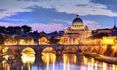 a view of a bridge over a river with a cathedral at Rome Luxury House - The House in Rome