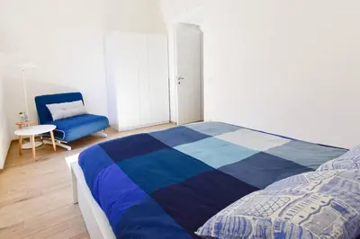 a white kitchen with a white table and a white table at Rome Lotto31 Apartment Garbatella in Rome