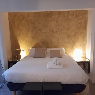 a bedroom with a large bed with two towels on it at Loft Farnese soggiorno 2 stanze 2 bagni luxury centro in Rome