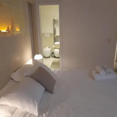 a bedroom with a white bed with two pillows at Loft Farnese soggiorno 2 stanze 2 bagni luxury centro in Rome