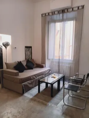 a living room with a couch and a table at Loft Farnese soggiorno 2 stanze 2 bagni luxury centro in Rome