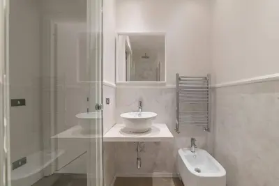a white bathroom with a sink and a shower at Loft Farnese soggiorno 2 stanze 2 bagni luxury centro in Rome