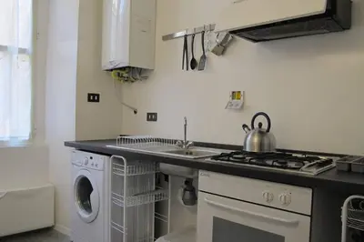 a kitchen with a sink and a washing machine at Loft Farnese luxury 3 stanze 3 bagni salotti cucina in Rome