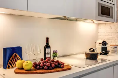 a bottle of wine and fruit on a cutting board on a kitchen counter at Capo Le Case Home 9 in Rome