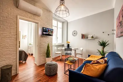 a living room with a blue couch and a table at Capo Le Case Home 9 in Rome