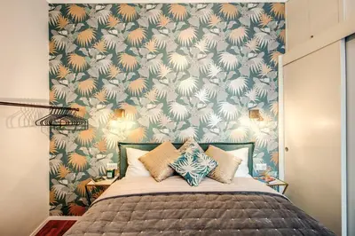a bedroom with a bed with a floral wallpaper at Capo Le Case Home 9 in Rome